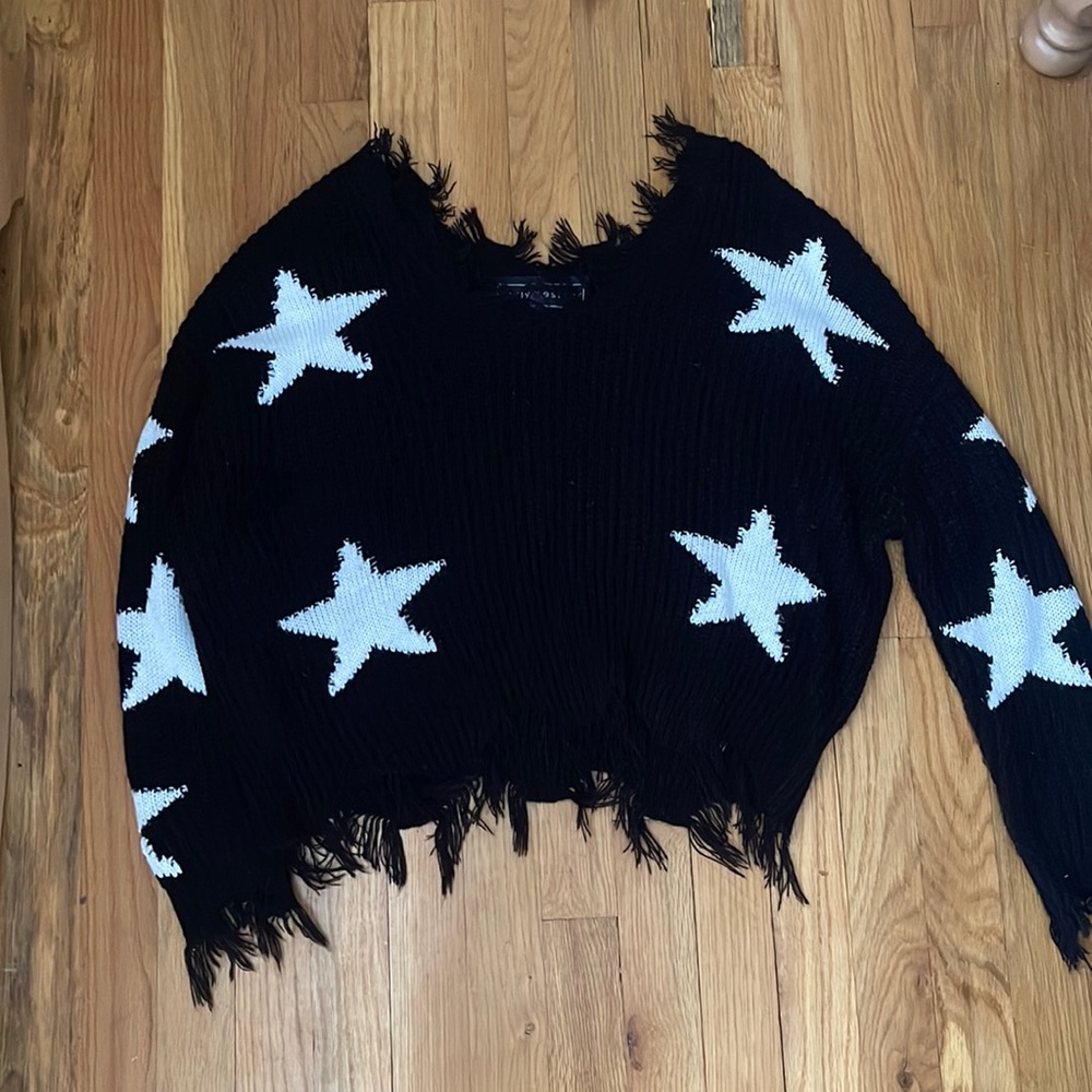 Distressed black cropped sweater with white stars
